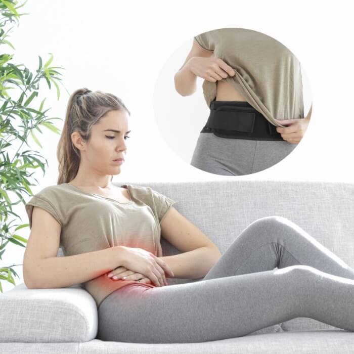 Pessoa a usar a faixa lombar térmica de forma discreta por baixo da roupa